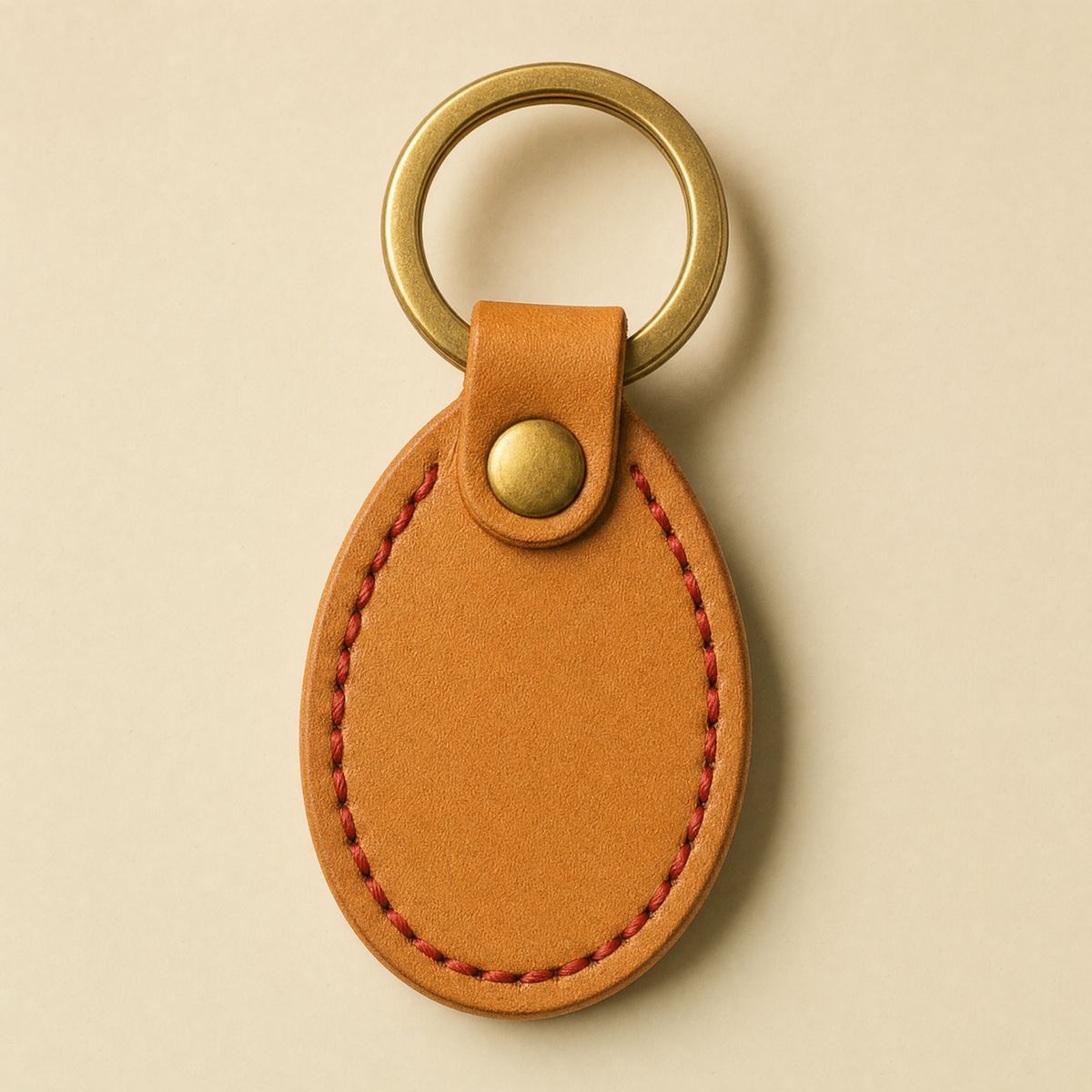 Shift keytag in tan leather with red stitching